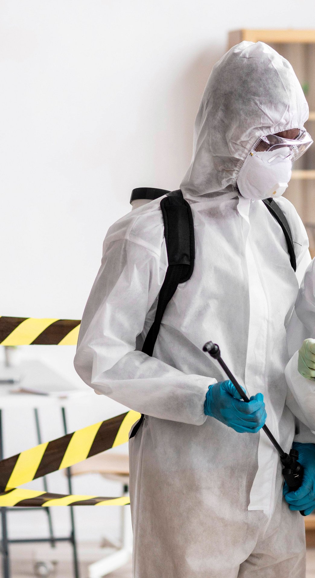 two people in hazmat suits and clipboardsq